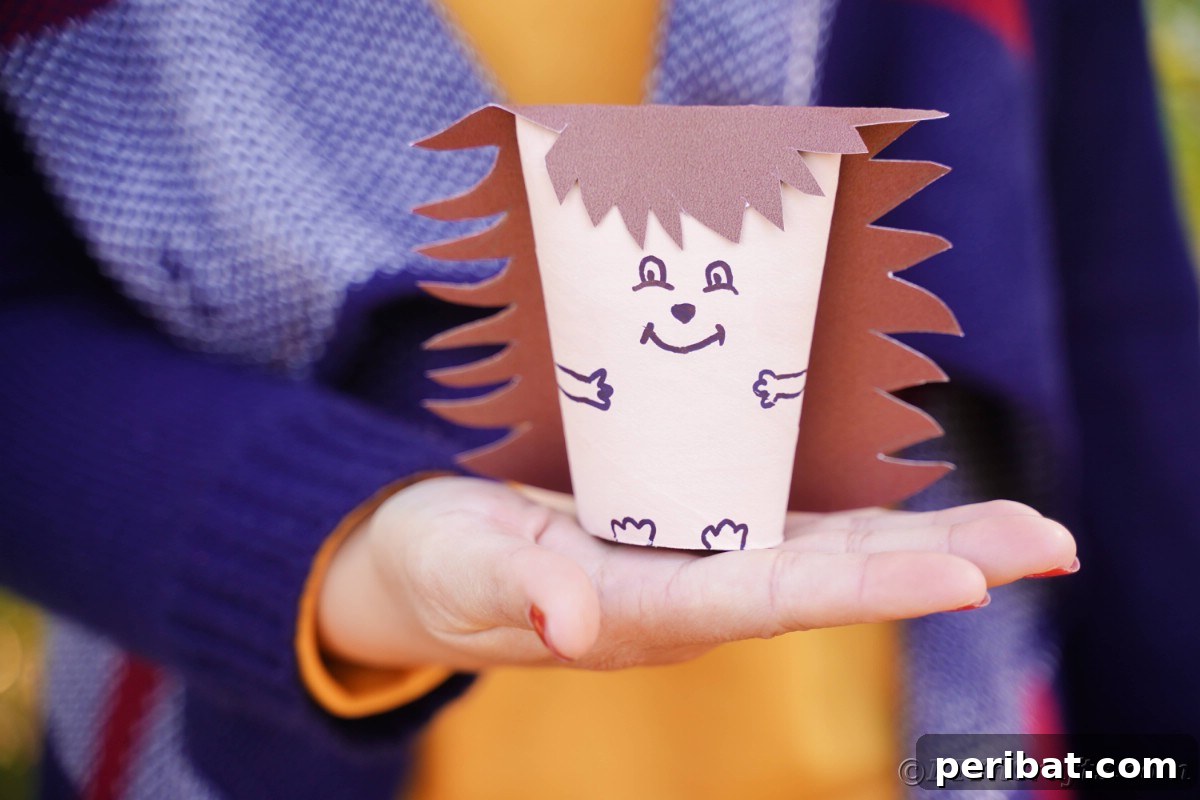 Charming Toilet Paper Roll Hedgehogs for Autumn 4 Womans hands holding toilet paper roll hedgehog