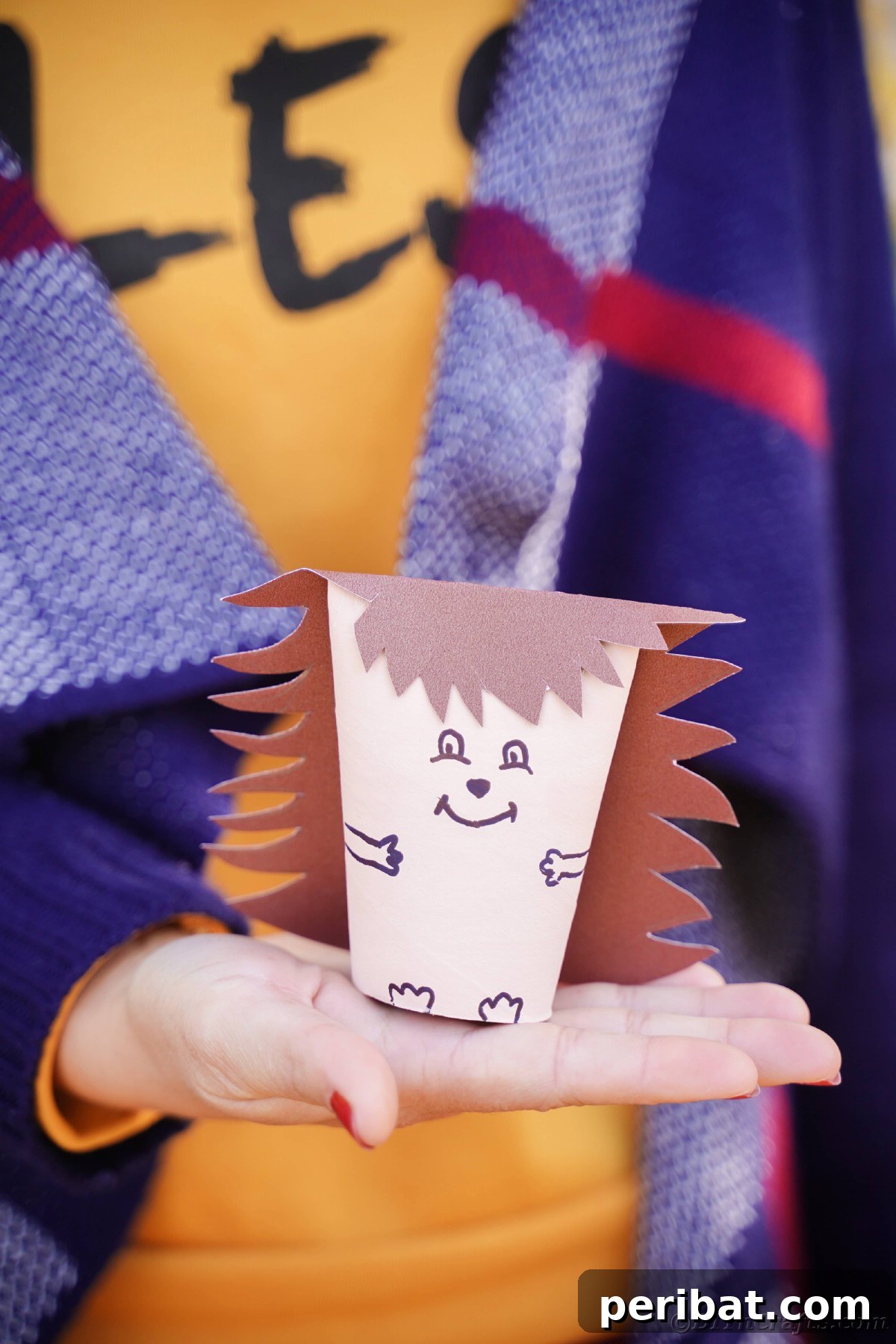 Charming Toilet Paper Roll Hedgehogs for Autumn 25 Woman in orange shirt holding toilet paper roll hedgehog