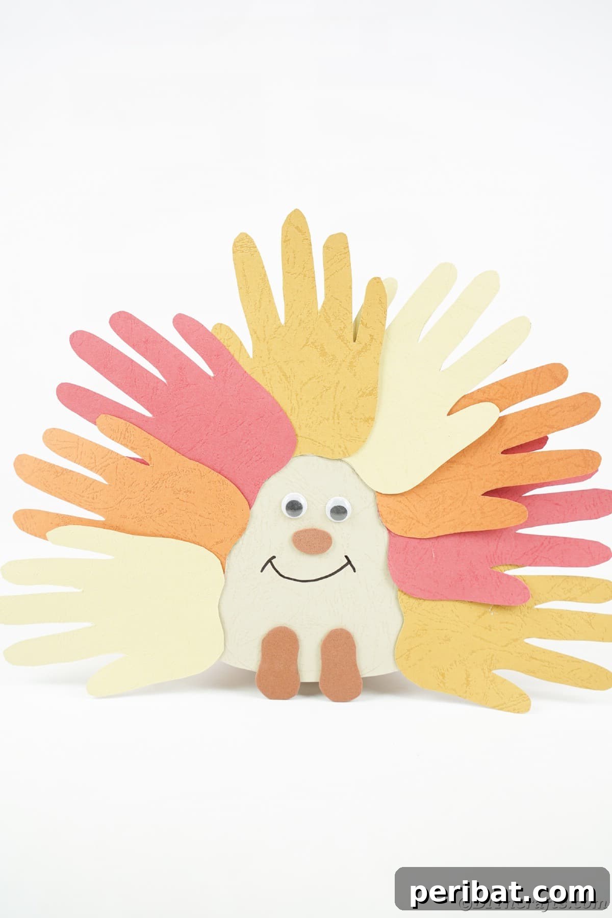 Autumn-themed handprint hedgehog craft with vibrant fall colors, on a clean white background