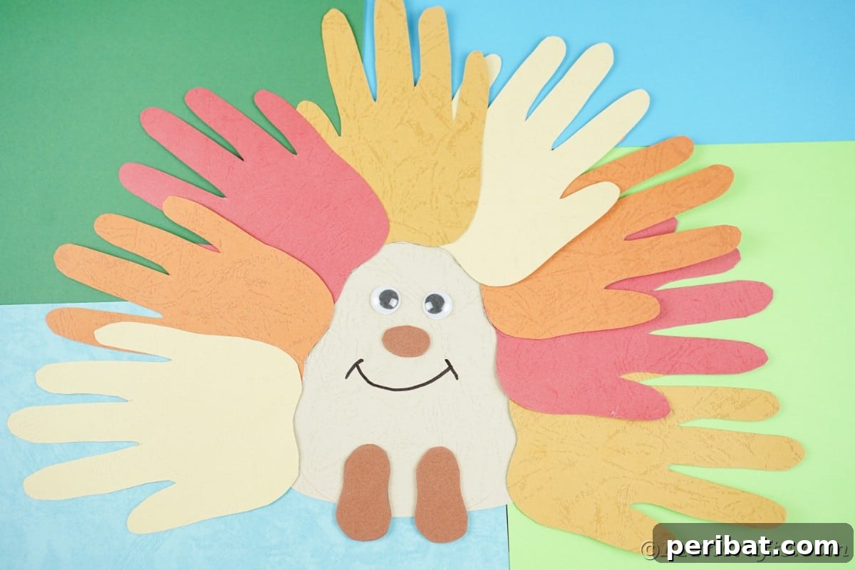 Colorful handprint paper hedgehog craft on a background of blue and green paper, ready for display