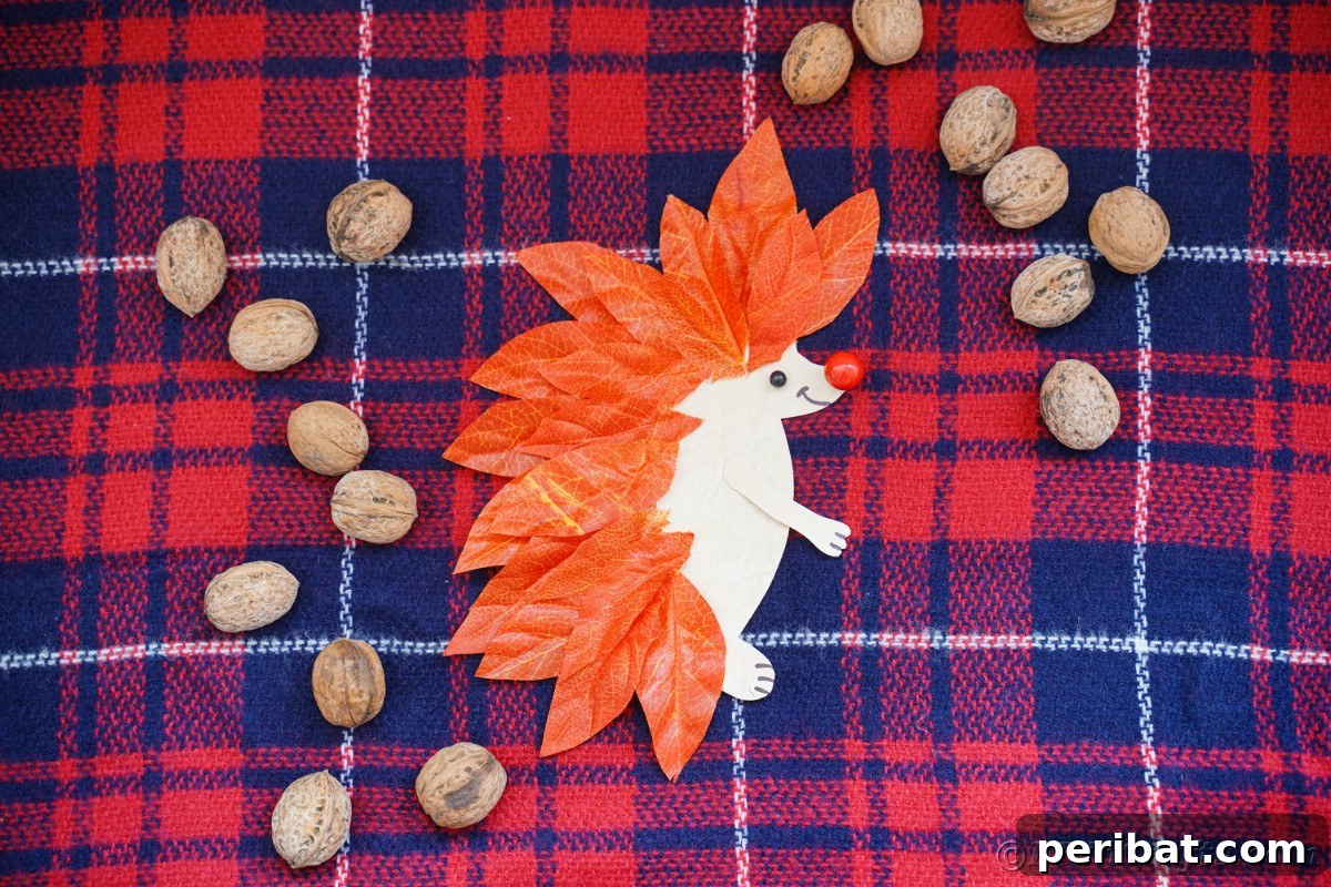 Paper hedgehog with whole pecans around it laying on plaid fabric, ideal for fall decoration.