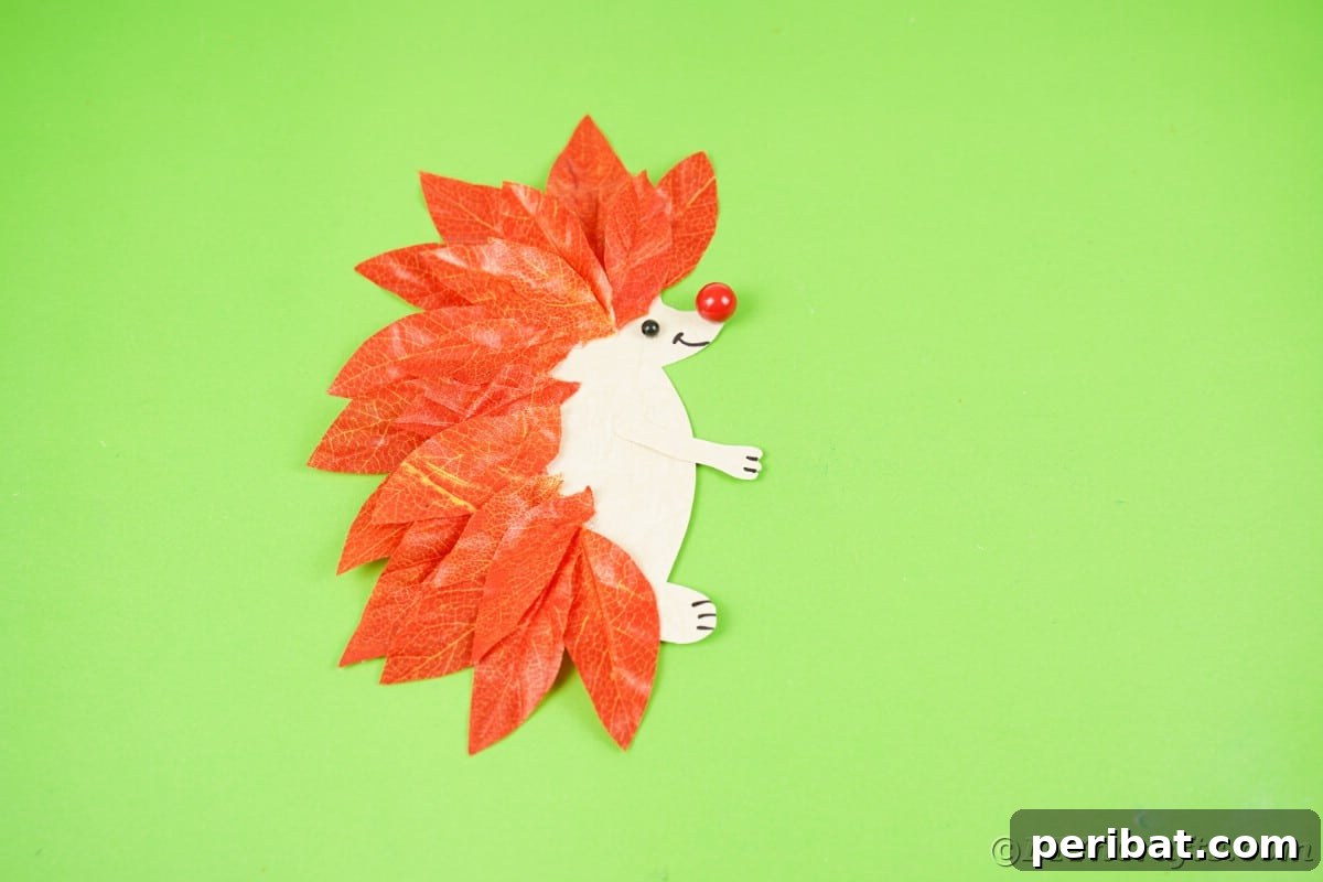 Paper hedgehog on green table, showing finished product.