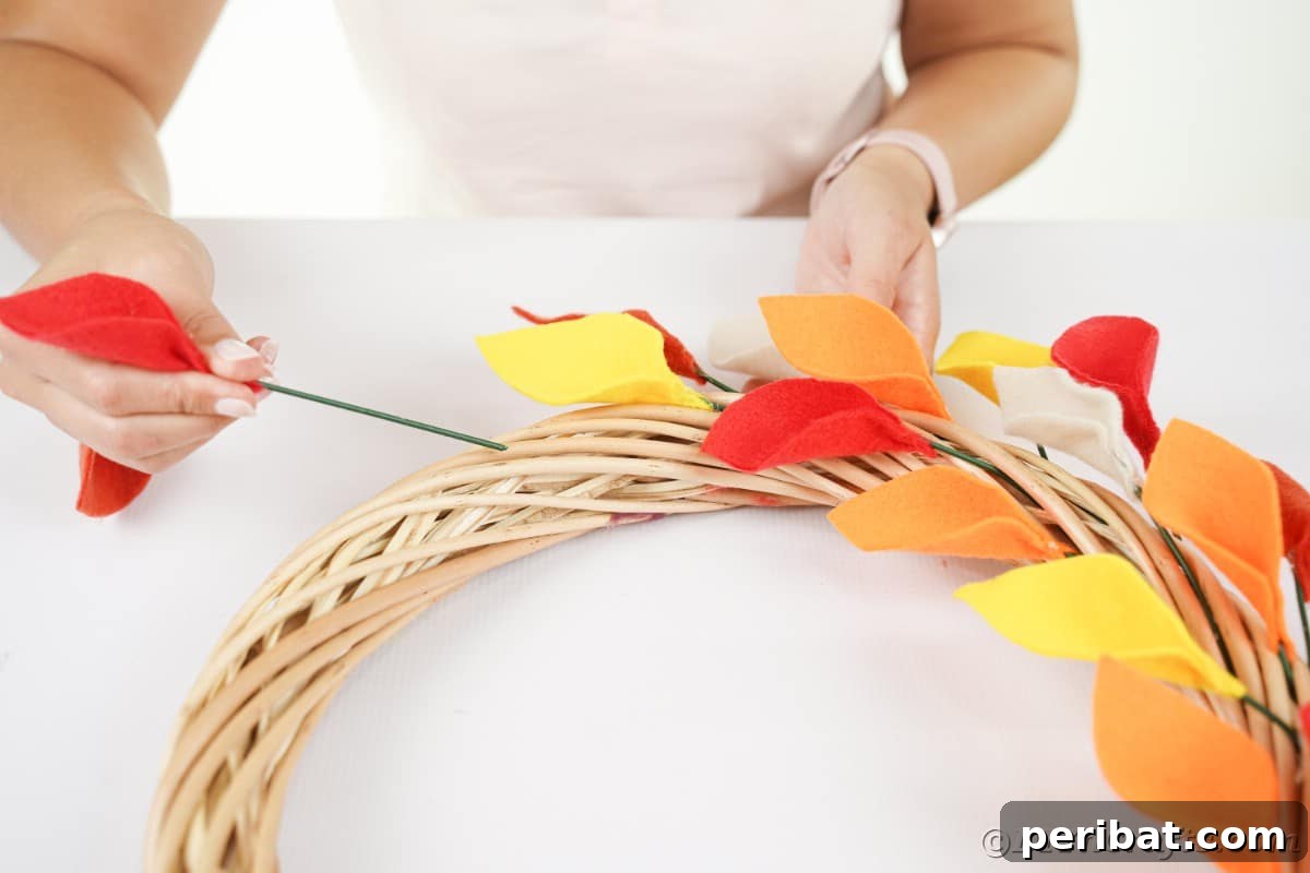 Adding leaves to grapevine wreathj