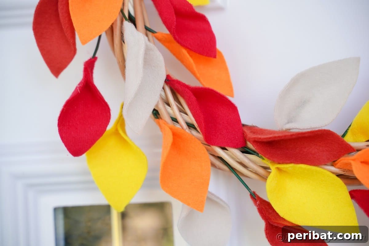 Close up image of fall leaf wreatha gainst white door