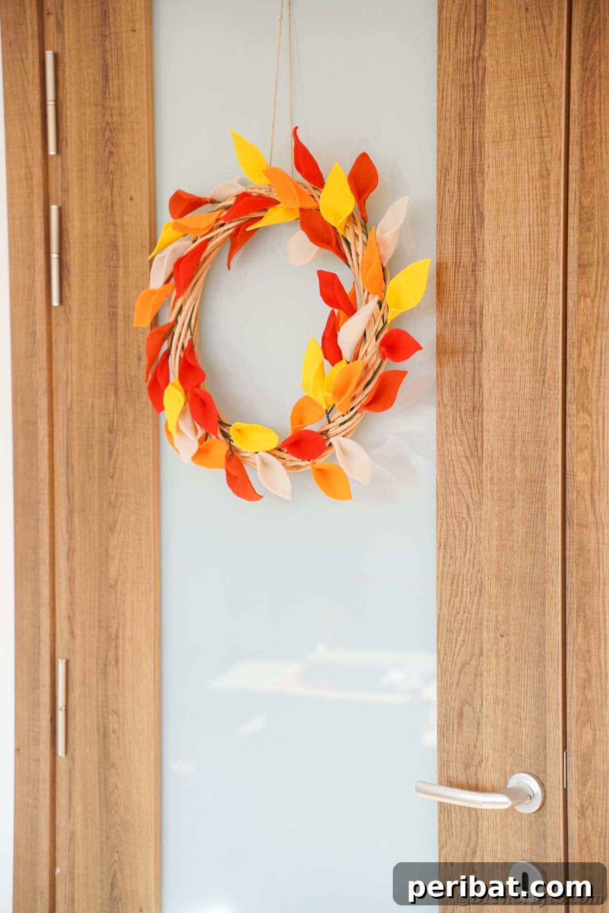 Wood and glass door with leaf wreath
