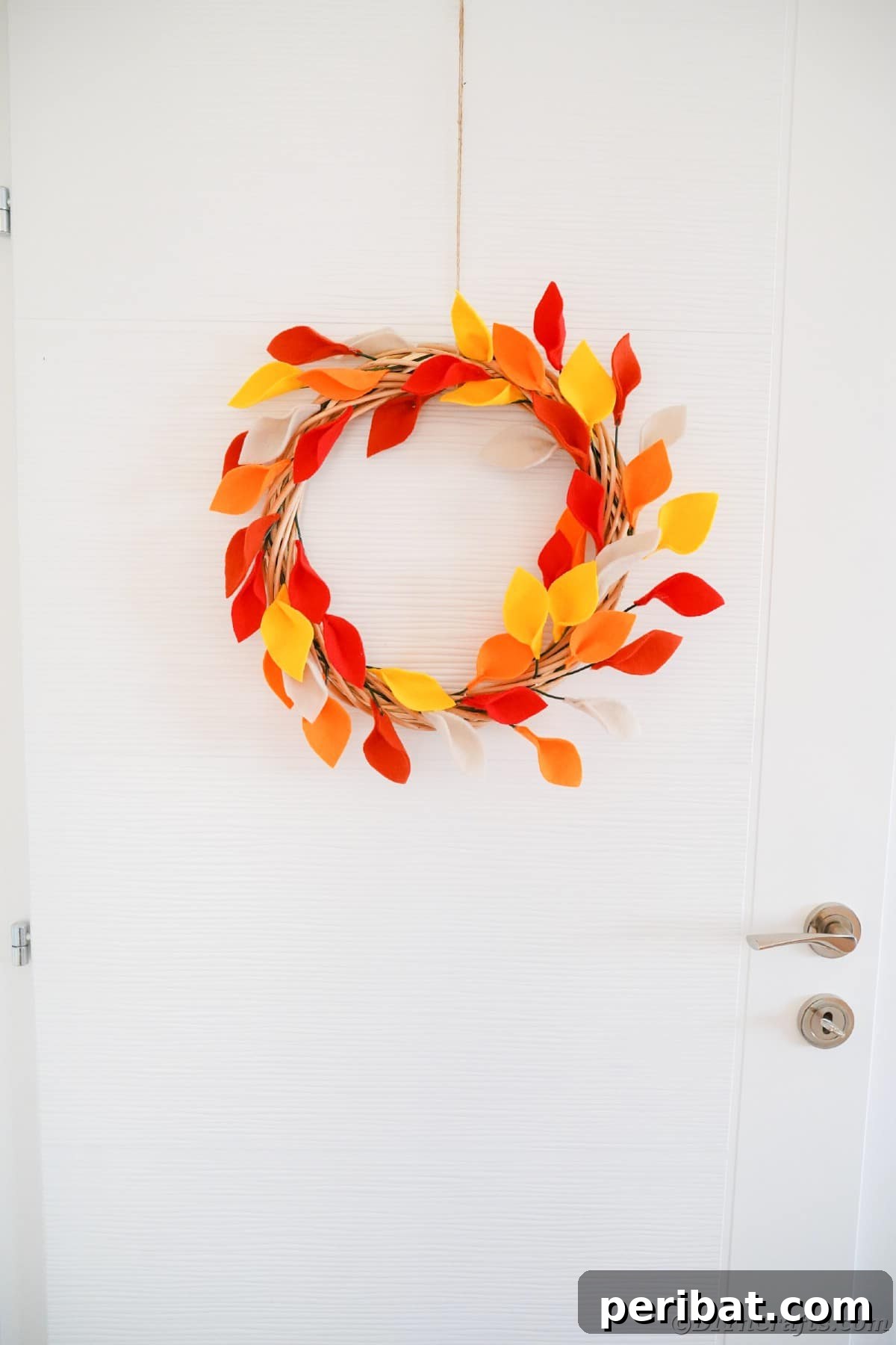 Leaf wreath hanging on white door