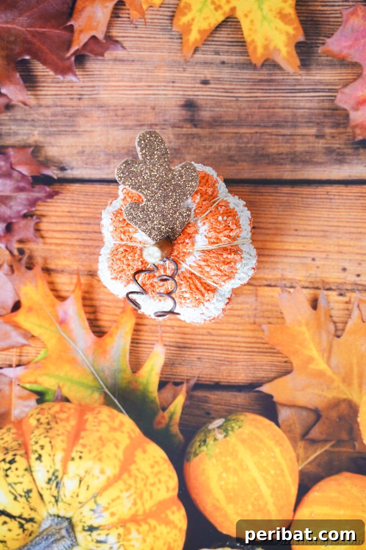 Cozy Sock Pumpkins Fall Home Decor 21 Striped fabric pumpkin sitting on fall seasonal paper, a delightful and simple autumn accent
