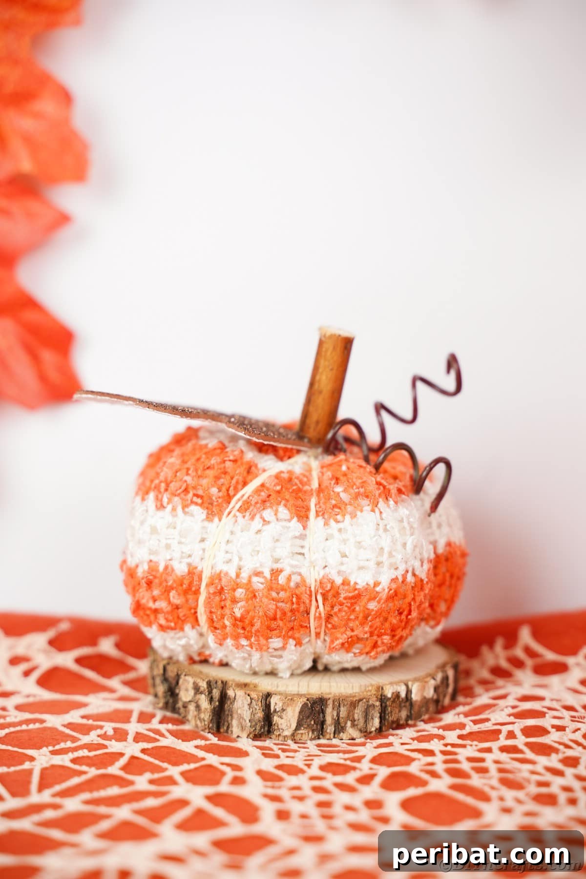 Cozy Sock Pumpkins Fall Home Decor 24 Fabric pumpkin sitting on wood slice, a perfect blend of rustic and natural aesthetics