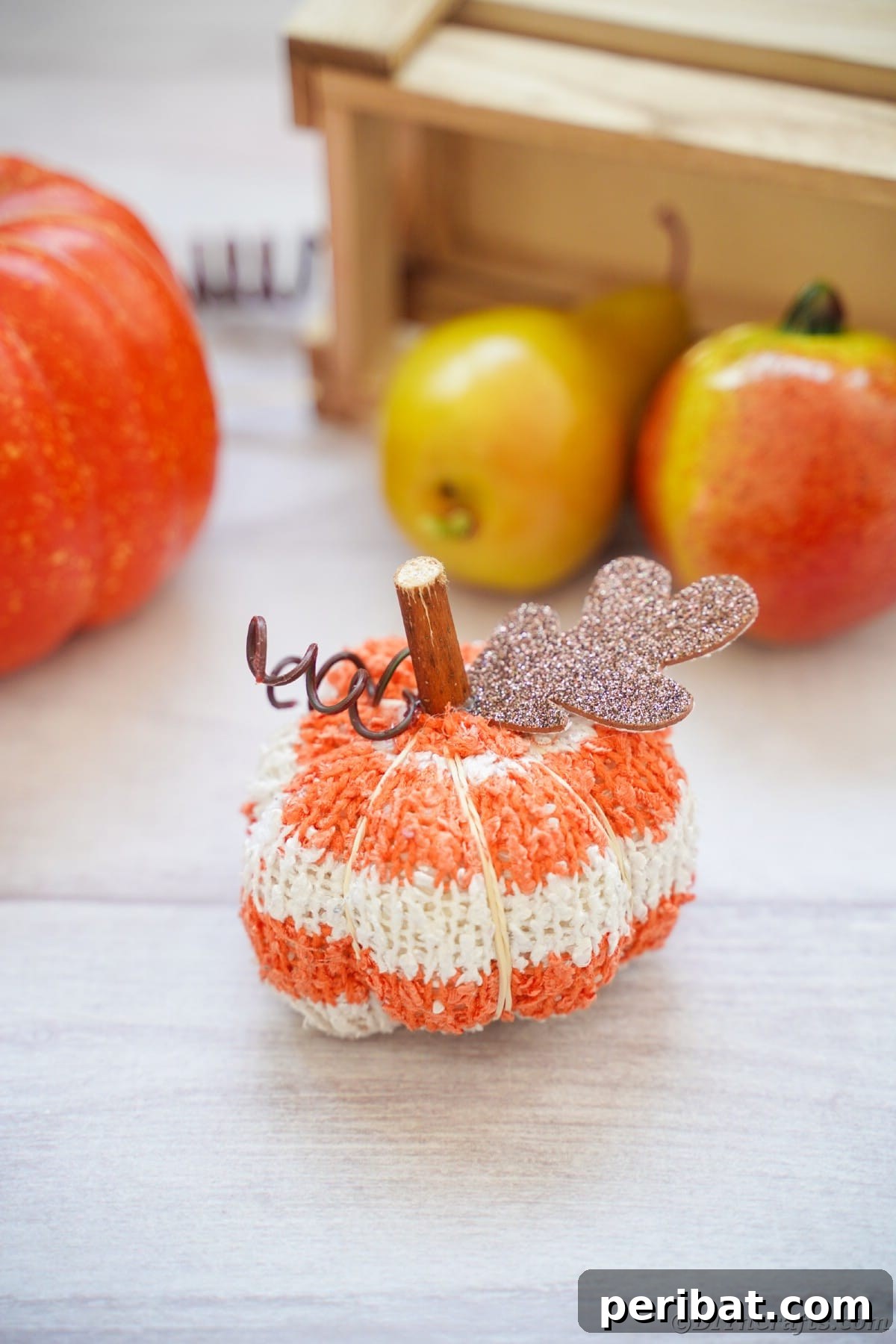 Cozy Sock Pumpkins Fall Home Decor 7 Orange and white striped fabric pumpkin on white table, a charming minimalist fall decoration