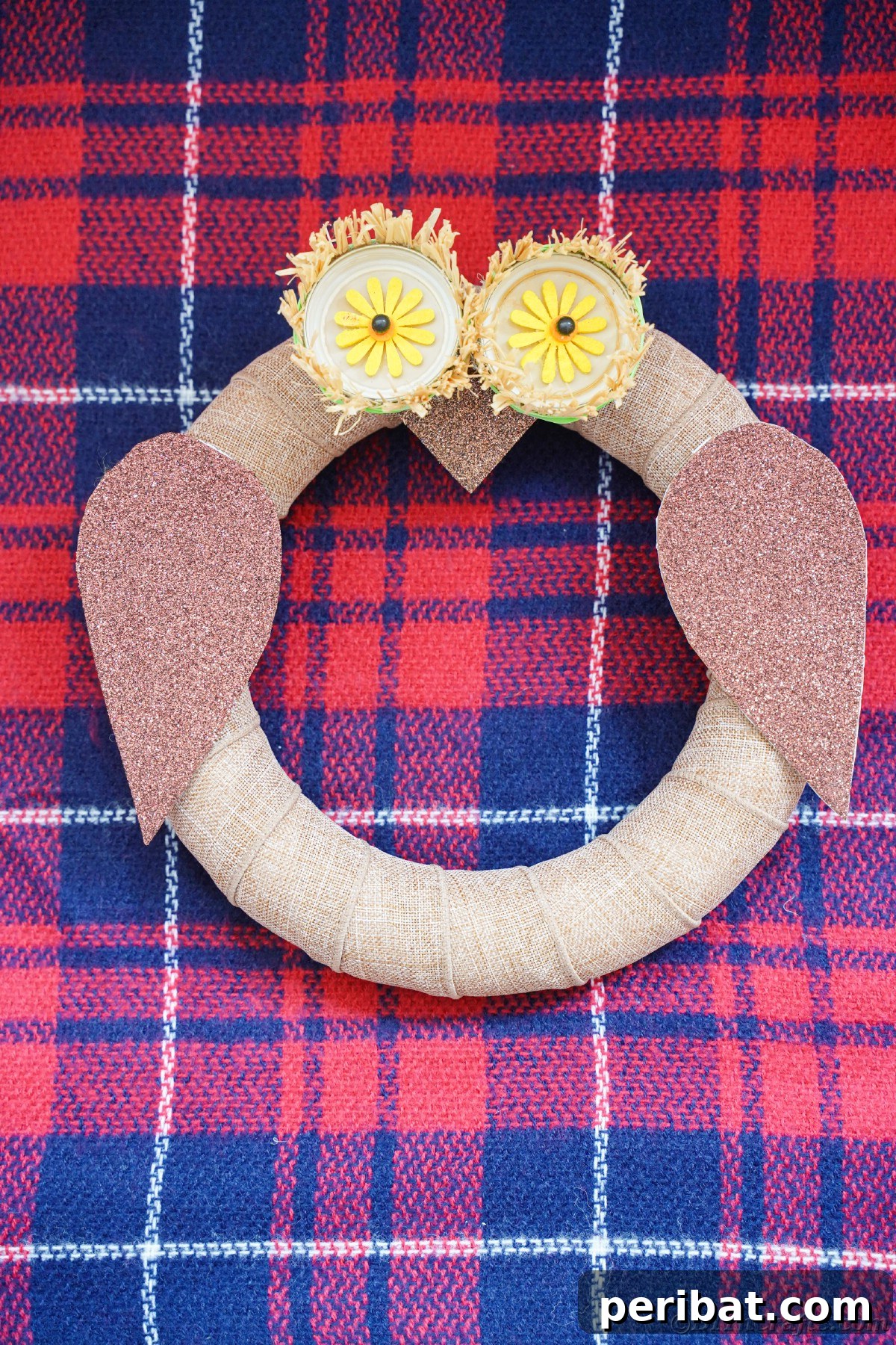 Farmhouse Burlap Owl Wreath 2 Burlap owl on plaid fabric, showcasing a rustic owl wreath, perfect for fall and year-round decor