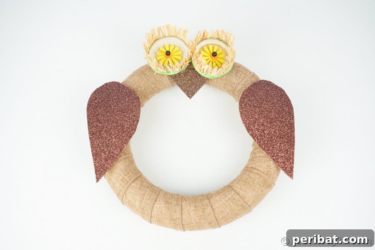 Farmhouse Burlap Owl Wreath 21 Burlap owl wreath on white table, showcasing the finished DIY project ready for display
