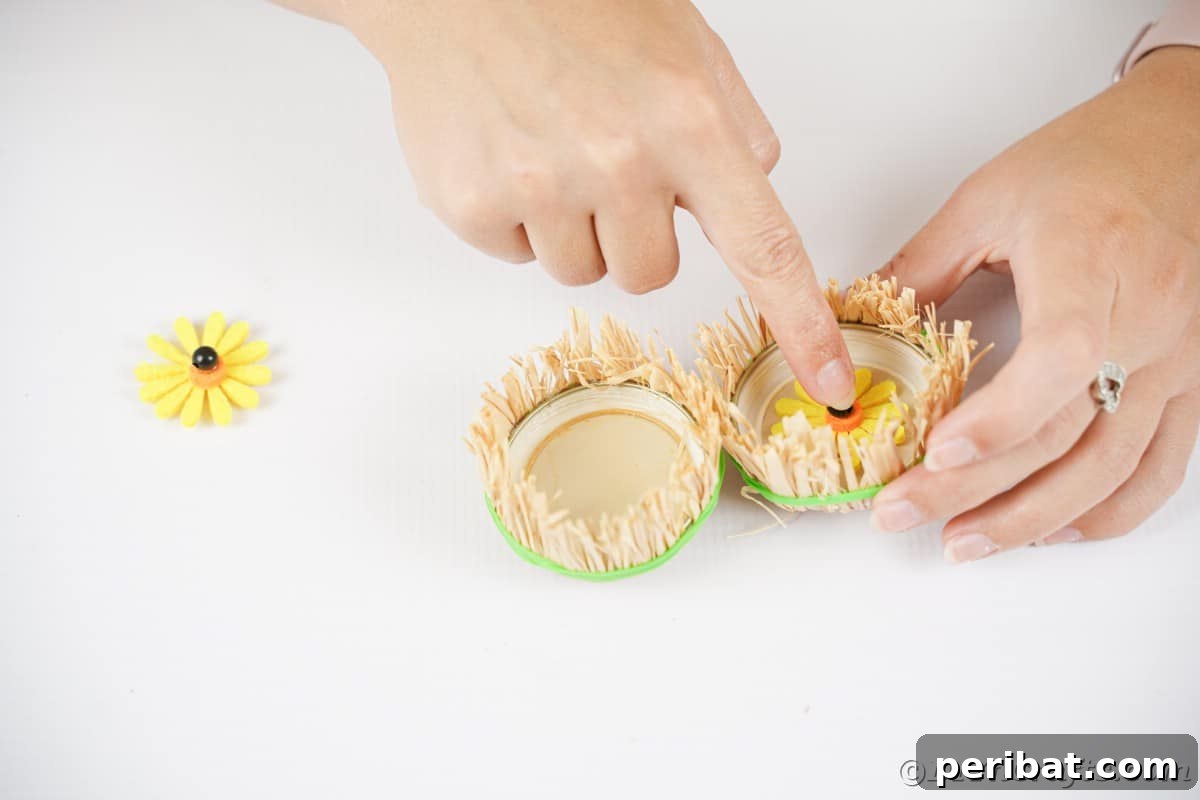Farmhouse Burlap Owl Wreath 16 Adding sunflower to middle of jar lid "eye", showing the final assembly of the owl