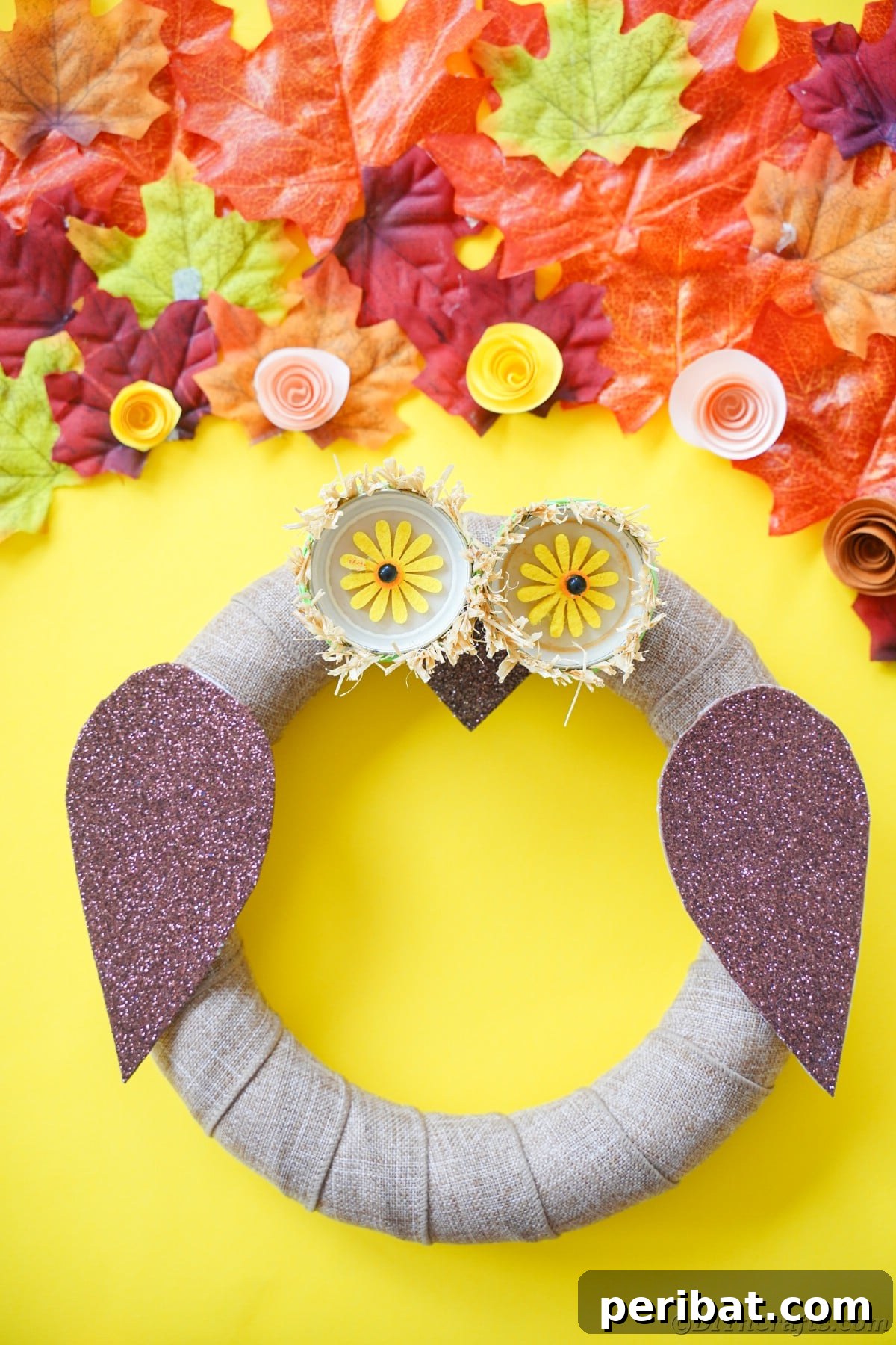 Farmhouse Burlap Owl Wreath 4 Yellow background behind owl wreath, highlighting the warm, inviting colors of the DIY decor