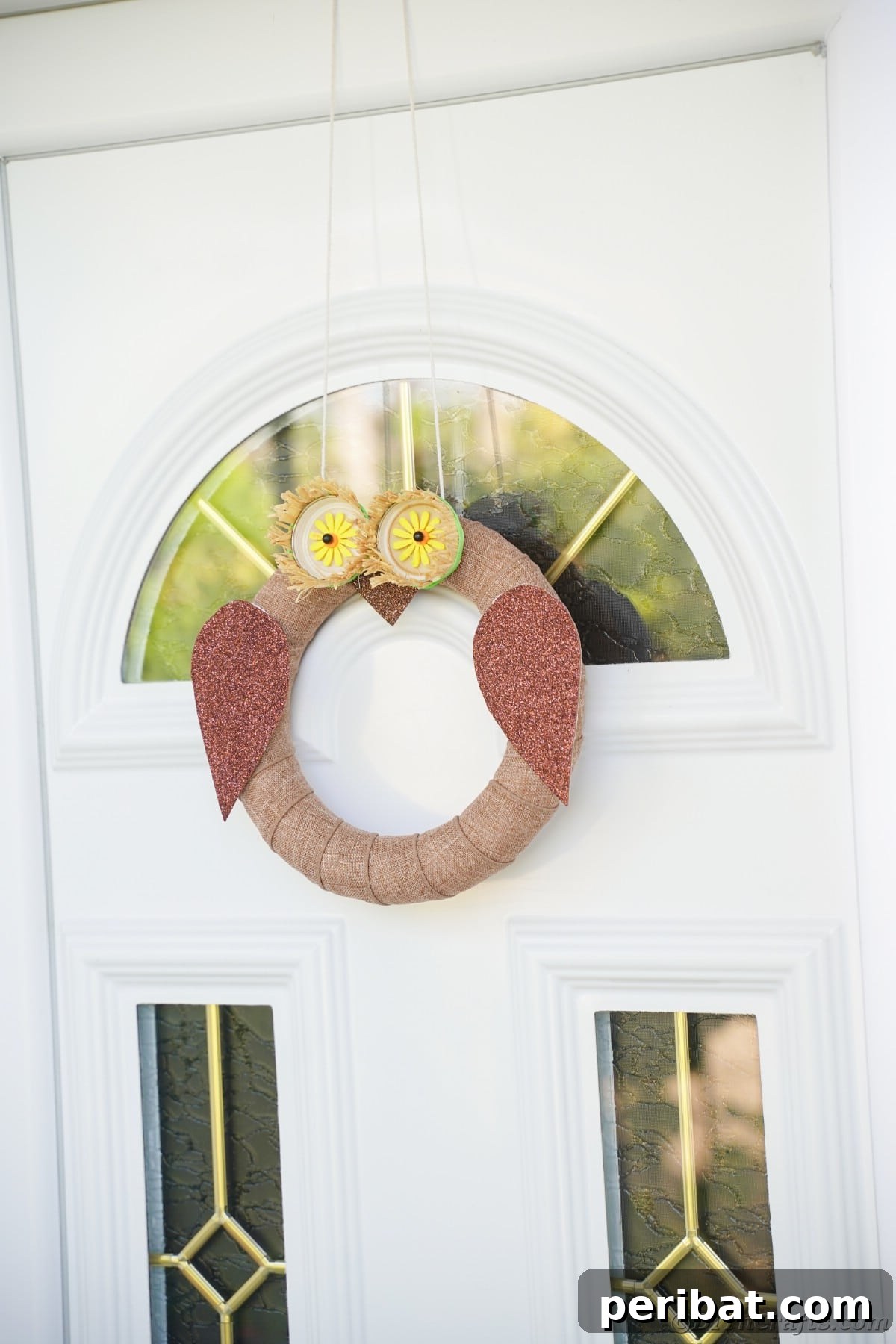 Farmhouse Burlap Owl Wreath 23 White door with glass panels holding owl wreath, demonstrating the wreath's aesthetic on a contrasting door