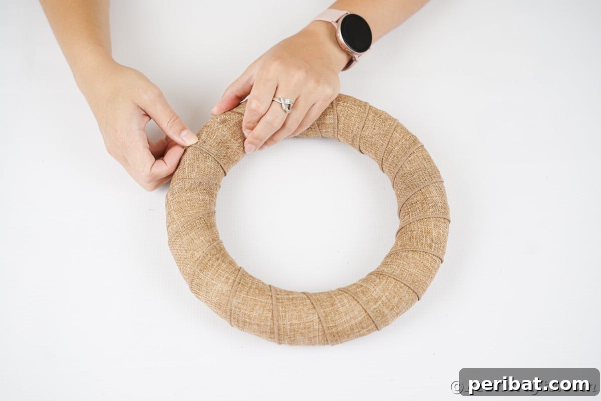 Farmhouse Burlap Owl Wreath 10 Hand wrapping wreath in burlap, showing the progression of covering the foam form