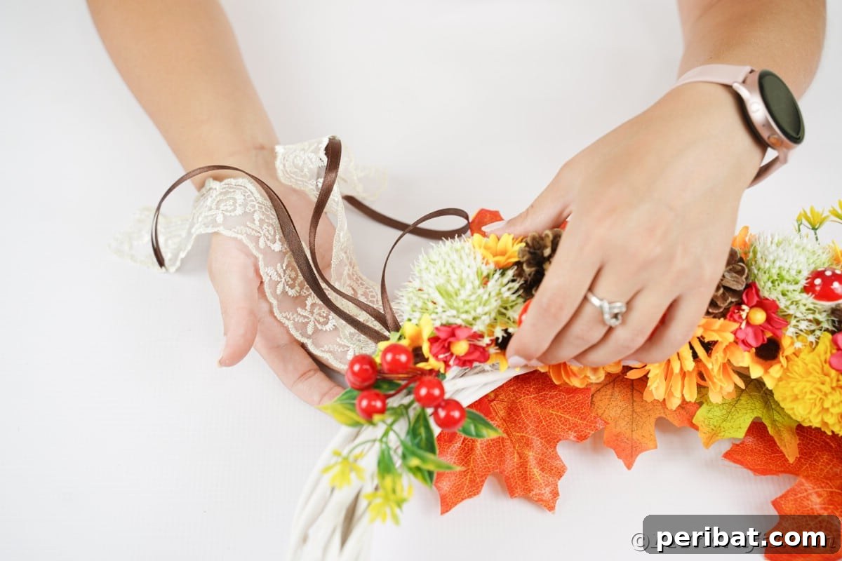 Charming Fall Blossom & Pinecone Wreath 14 Hand gluing lace to bottom of wreath