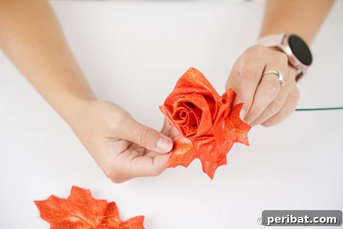Elegant Autumn Rose Displays Crafted from Faux Foliage 13 Hand touching leaf on fake rose