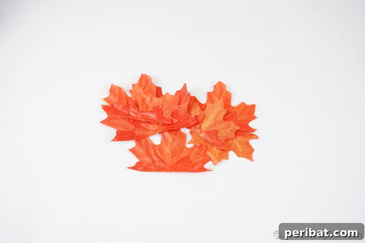 Elegant Autumn Rose Displays Crafted from Faux Foliage 15 Pile of fake leaves on white table