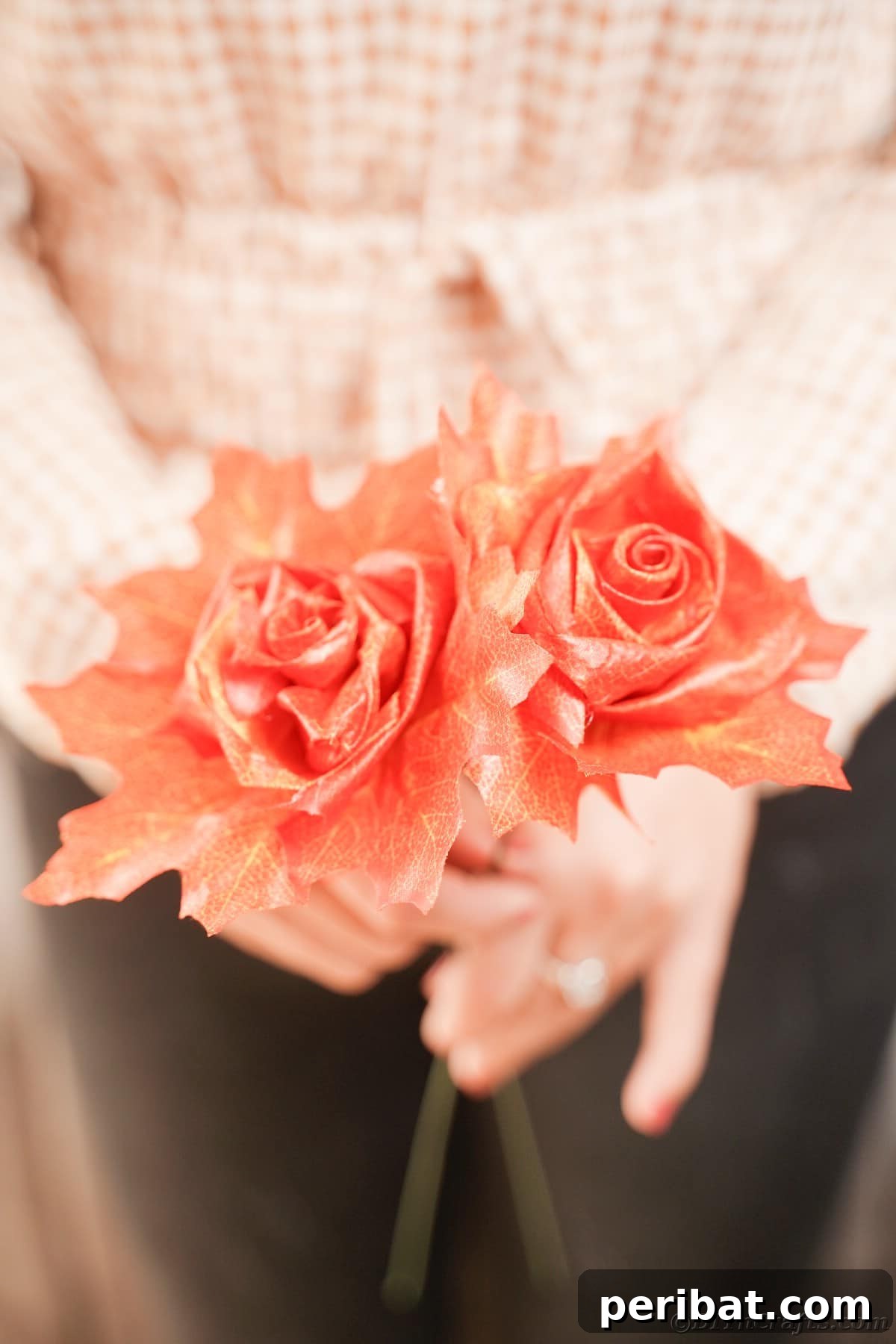 Elegant Autumn Rose Displays Crafted from Faux Foliage 21 Woman in black pants holding two fake roses