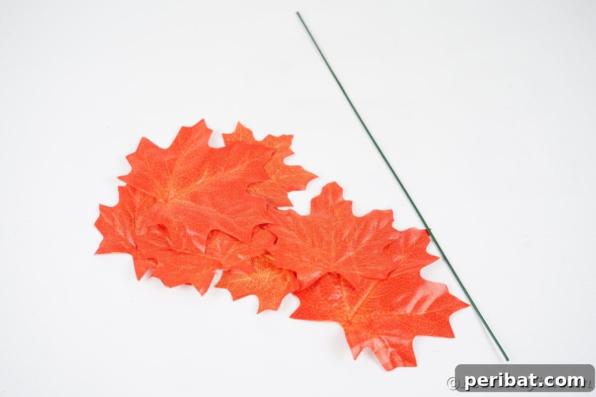 Elegant Autumn Rose Displays Crafted from Faux Foliage 7 Fake orange leaves and floral wire on white table