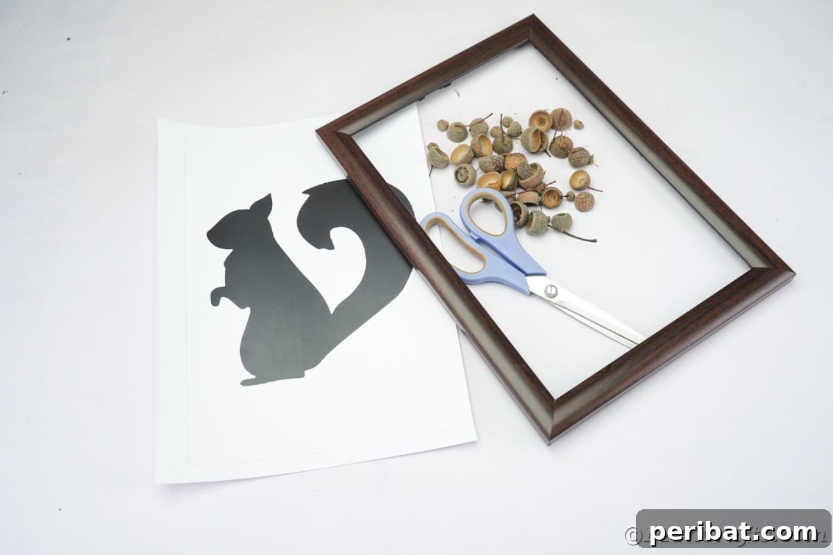 Charming Framed Squirrel with Acorn Cap Wall Decor 8 Picture frame, acorn caps, scissors, and template for squirrel on white table