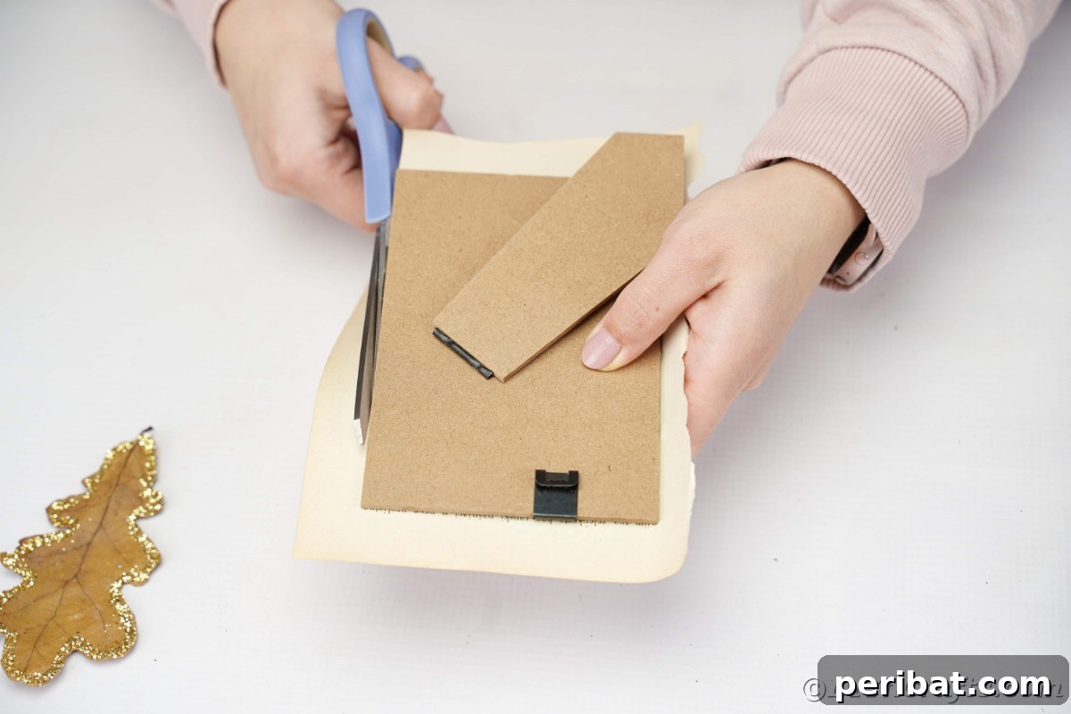 Blue scissors trimming a book page against a picture frame, ensuring a precise fit for the background.