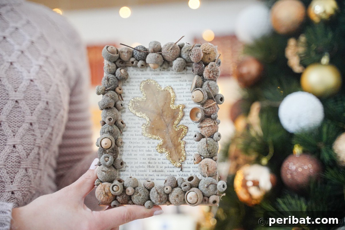 Acorn cap frame with a leaf held in front of a holiday tree, demonstrating its versatility for fall and winter decor.