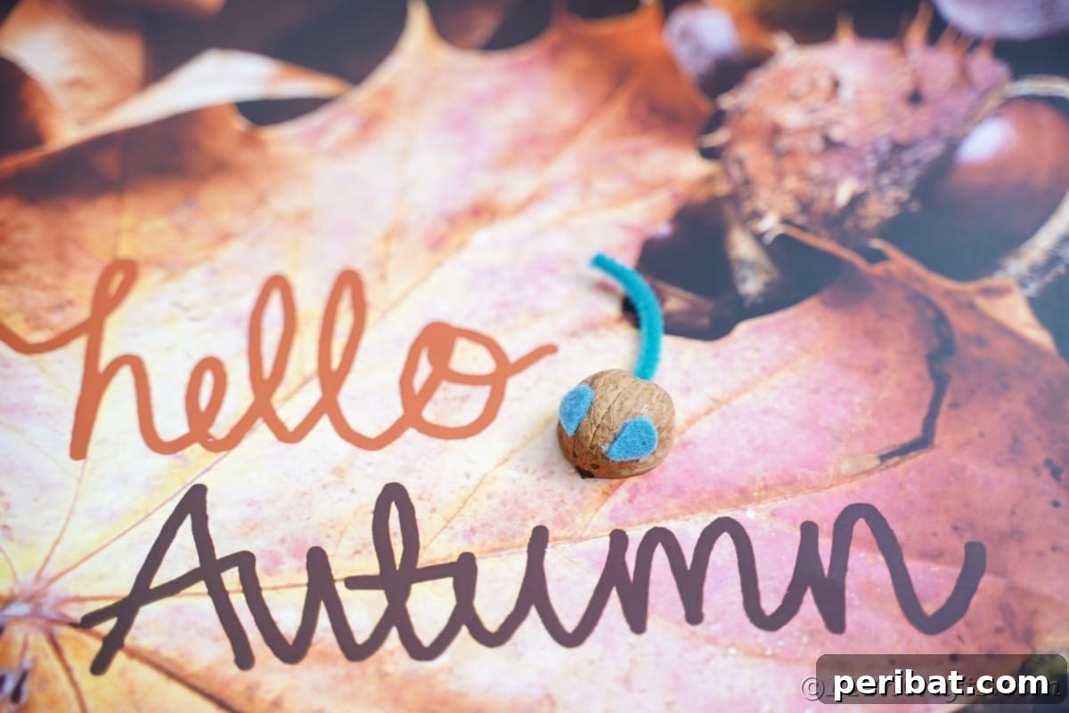 Walnut Wonders: Upcycled Shell Mouse Art 7 A 'Hello Autumn' sign with a rustic fake mouse positioned directly above the message, creating a cozy and inviting fall display.