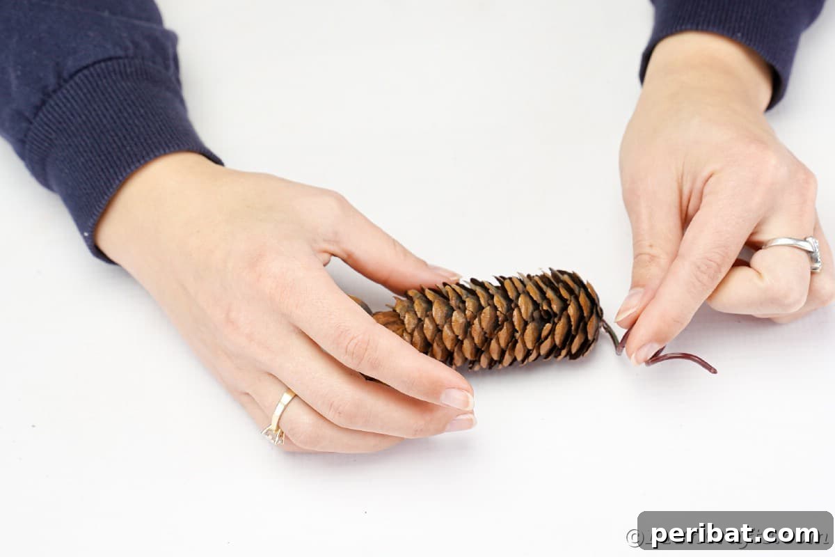 Adorable Pinecone and Pecan Mice Craft 12 hands gluing tail to mouse