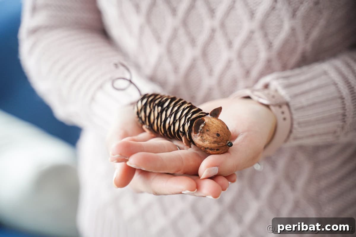 Adorable Pinecone and Pecan Mice Craft 15 pinecone mouse held by woman