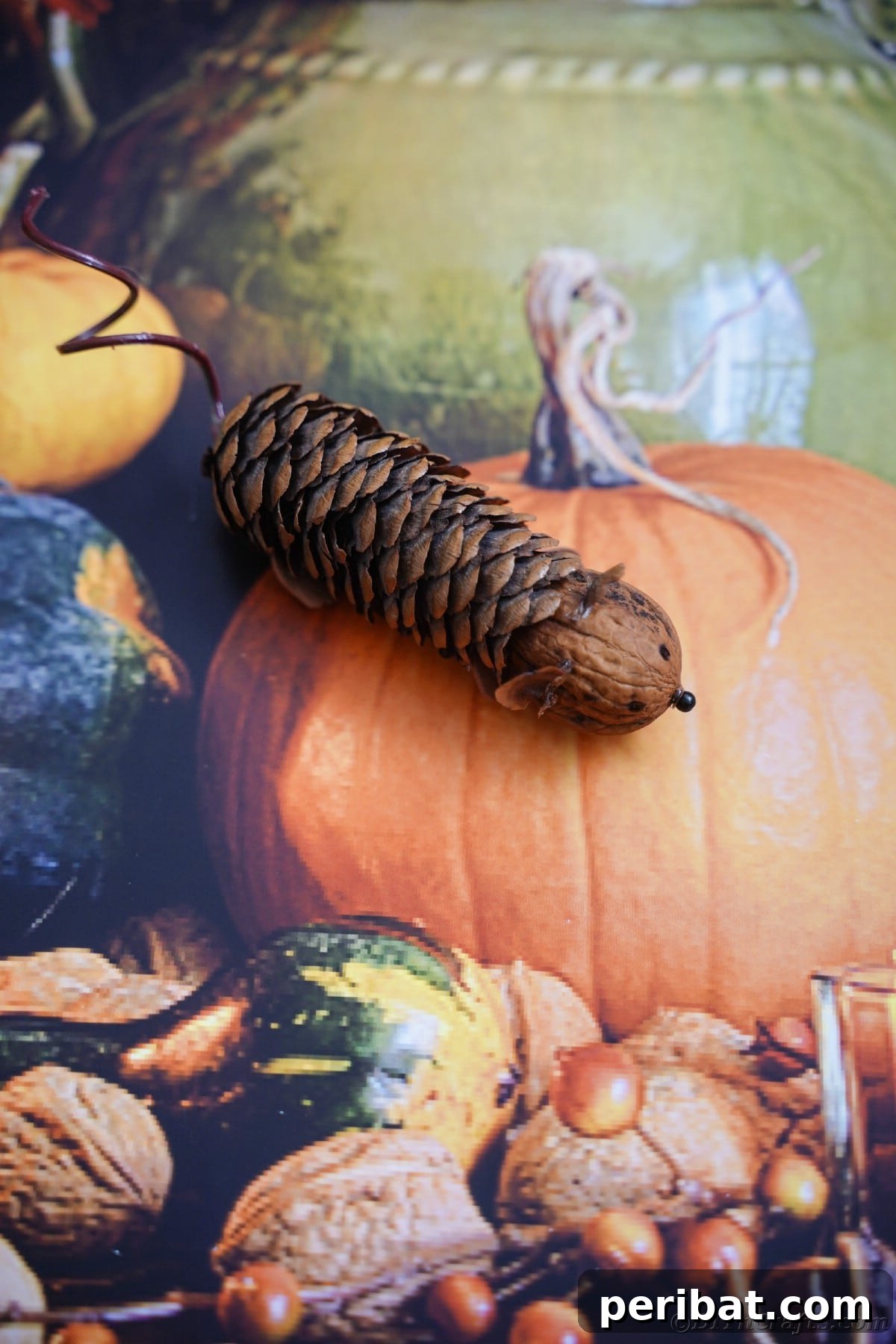 Adorable Pinecone and Pecan Mice Craft 22 pinecone mouse laying on top of pumpkin paper