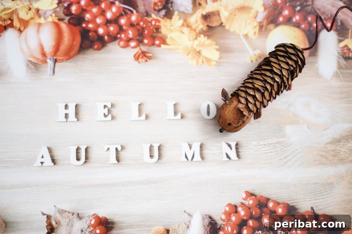 Adorable Pinecone and Pecan Mice Craft 6 hello autumn written in white letters on fall paper underneath fake mouse