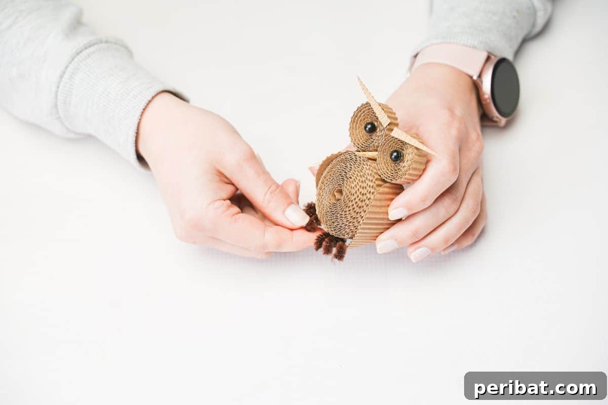 Rustic Rolled Cardboard Owl Art 22 hand gluing pipe cleaner feet onto owl