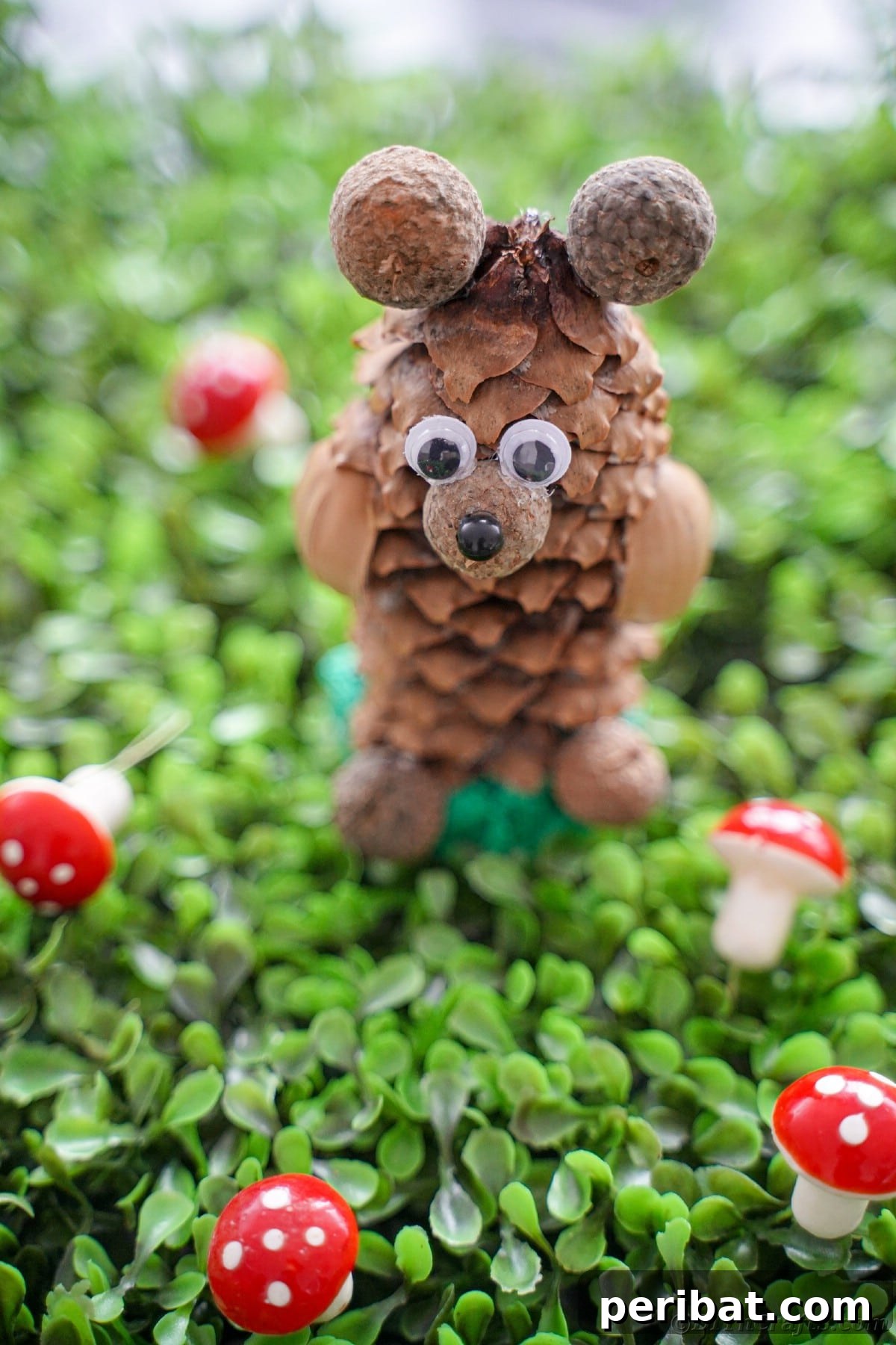 Cute pinecone bear sitting on green clover with miniature toadstools