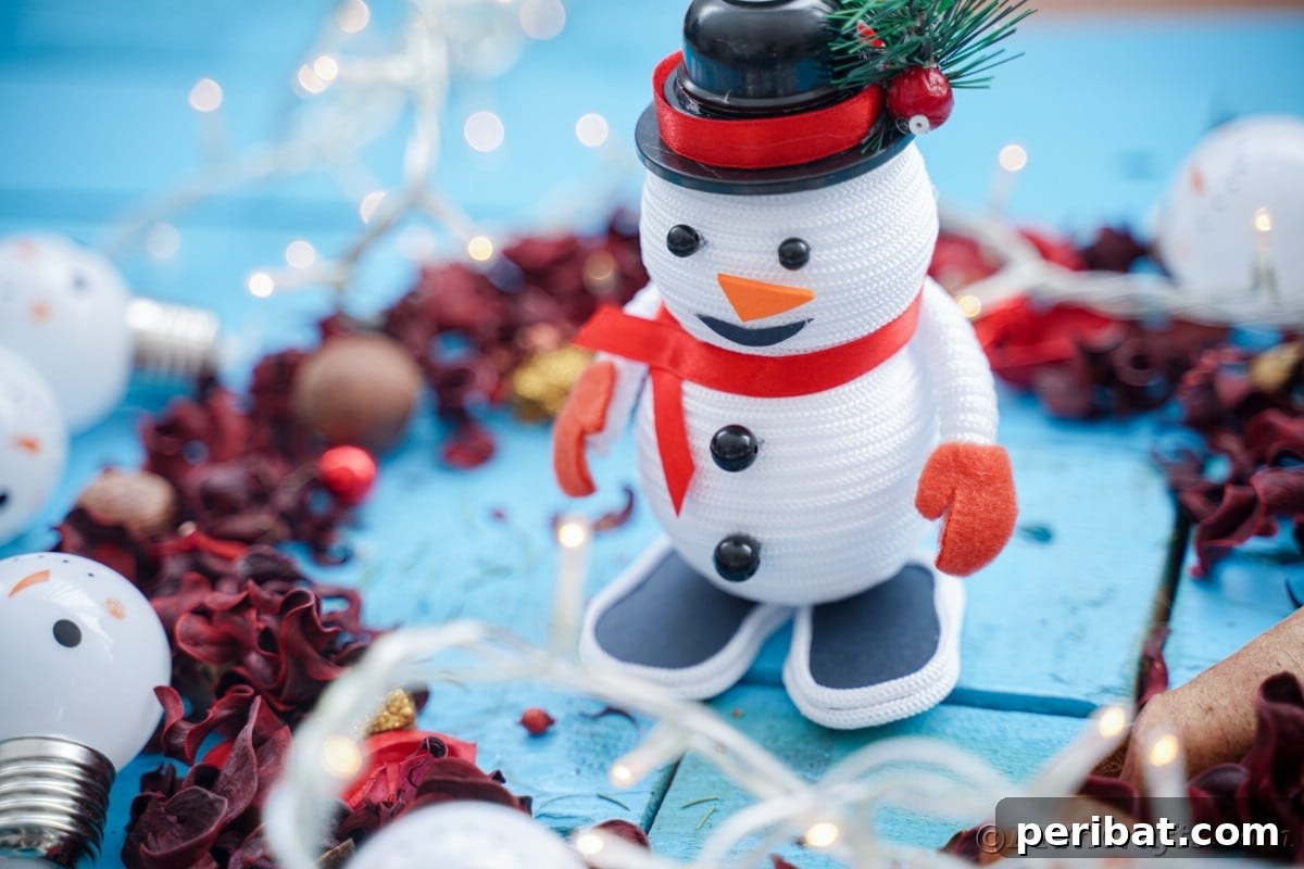 Cozy Twine Snowman Christmas Charm 3 rope snowman with red ribbon on blue table by pinecones