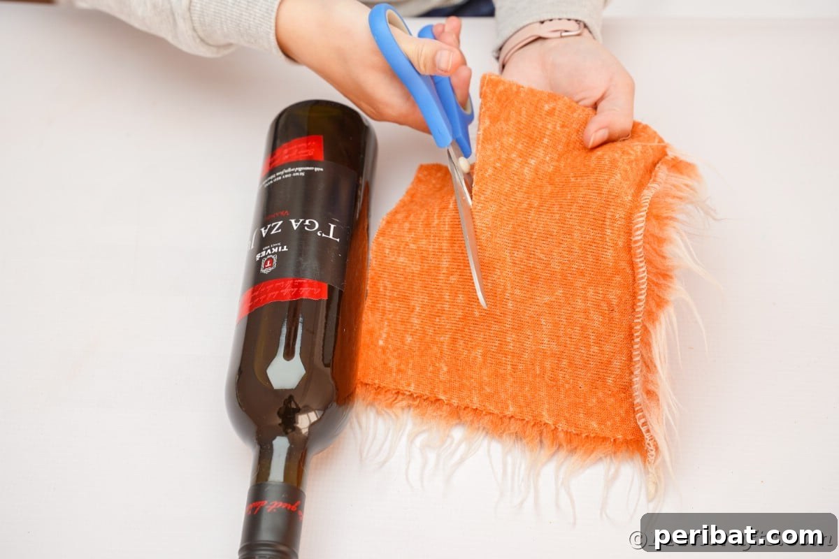 Carefully cutting fake fur into a triangular shape to form the gnome's beard.