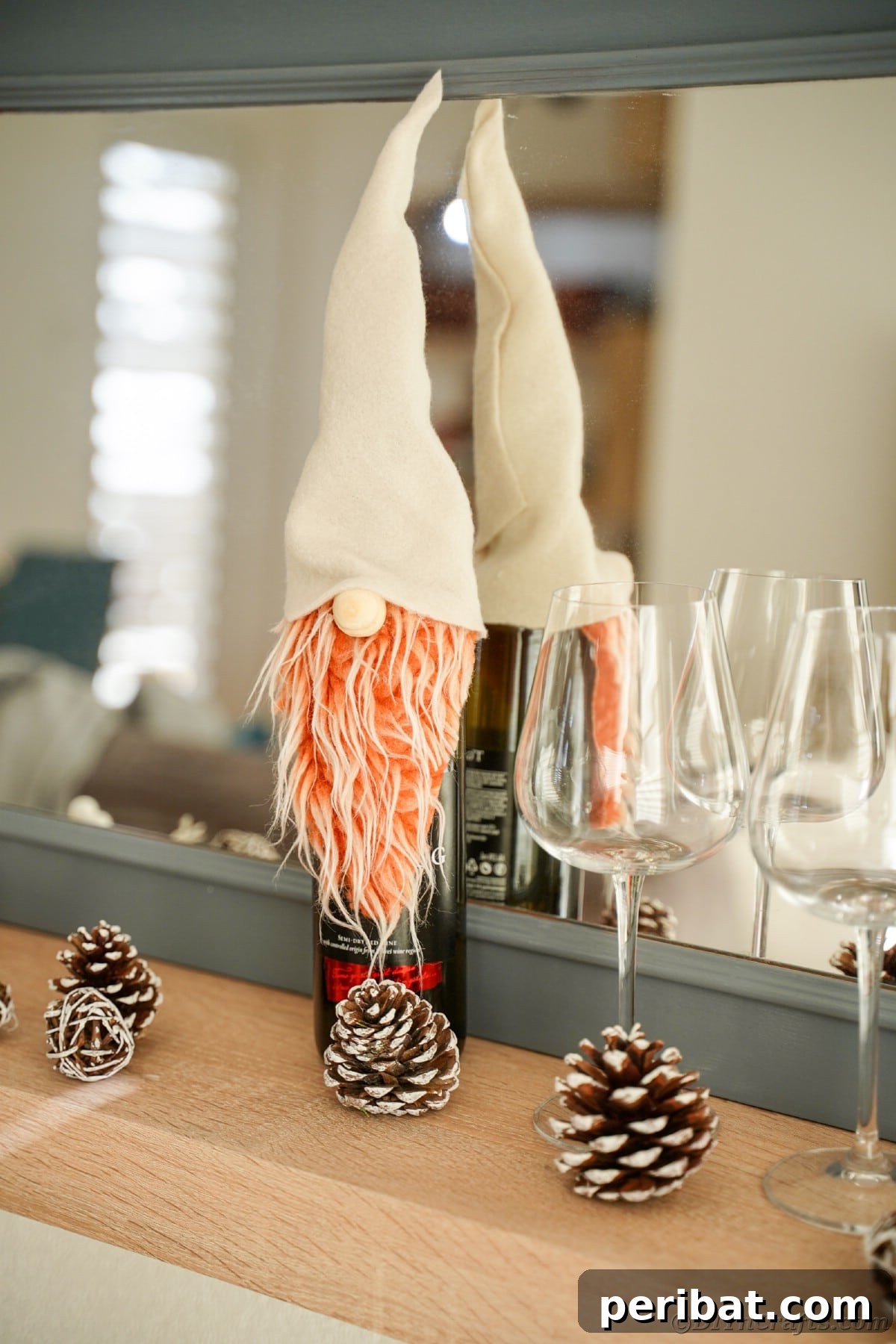 A wine bottle adorned with a gnome cover, placed in front of a gray mirror, adding a whimsical touch to the decor.