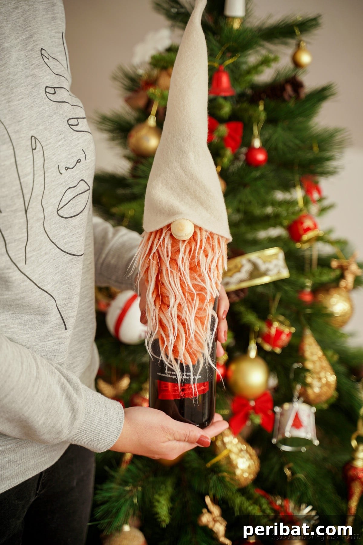 A woman holding a wine bottle beautifully adorned with a gnome cover, showcasing the finished craft.