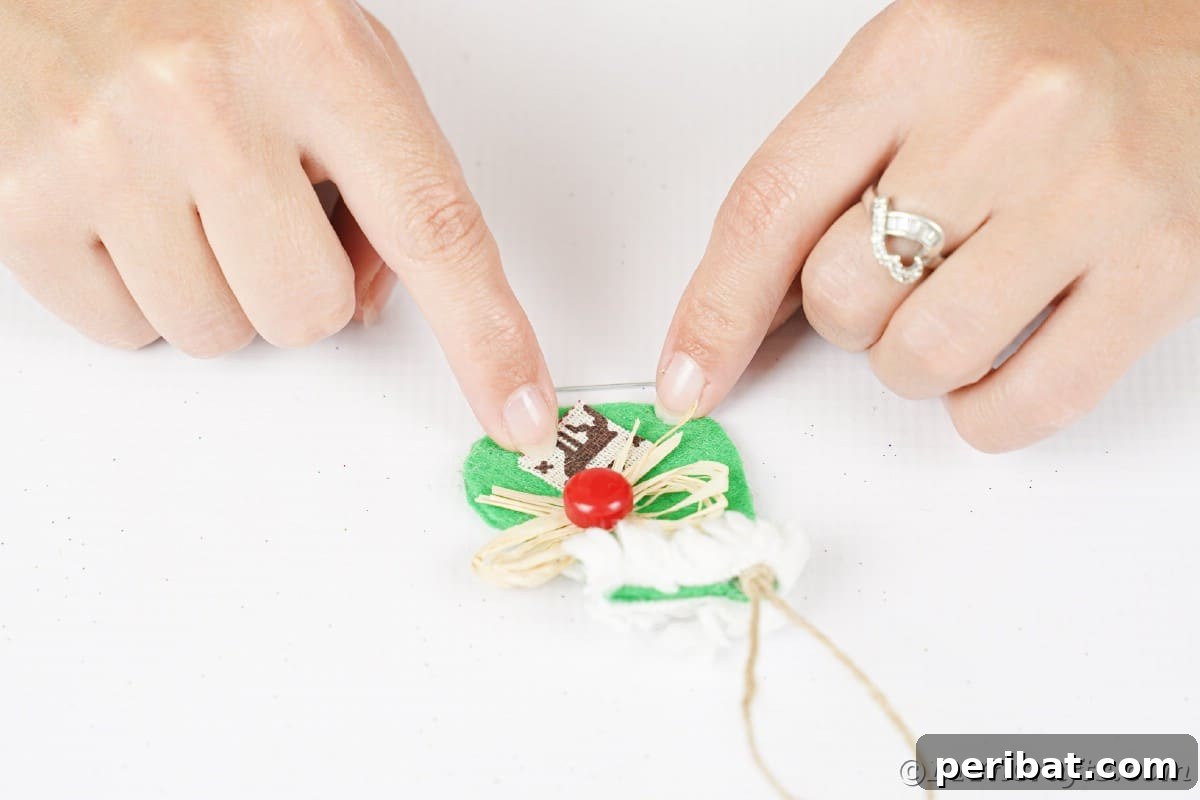 hands gluing reindeer fabric onto green ice skate ornament