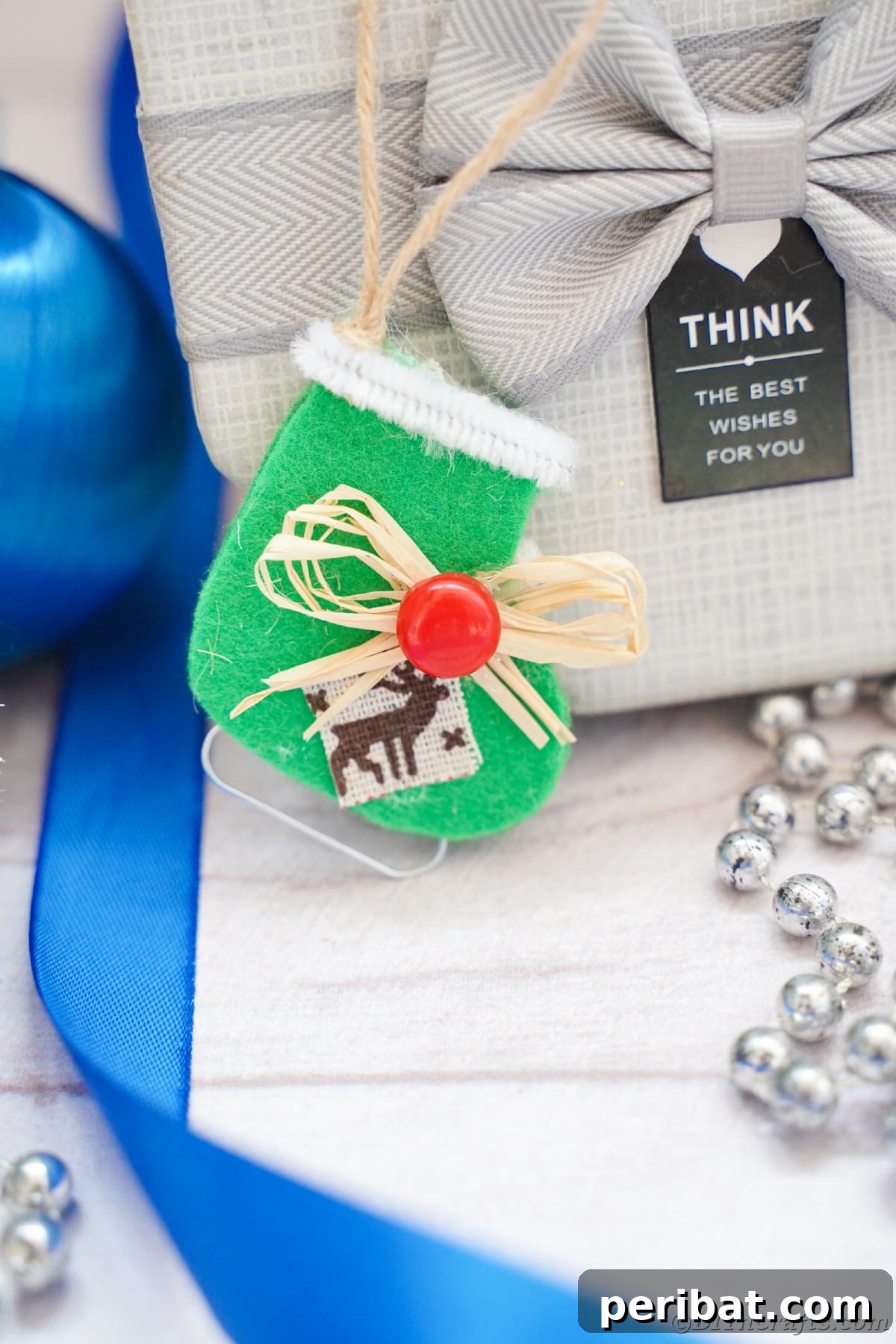 felt ice skate hanging on silver package with blue ribbon to the side