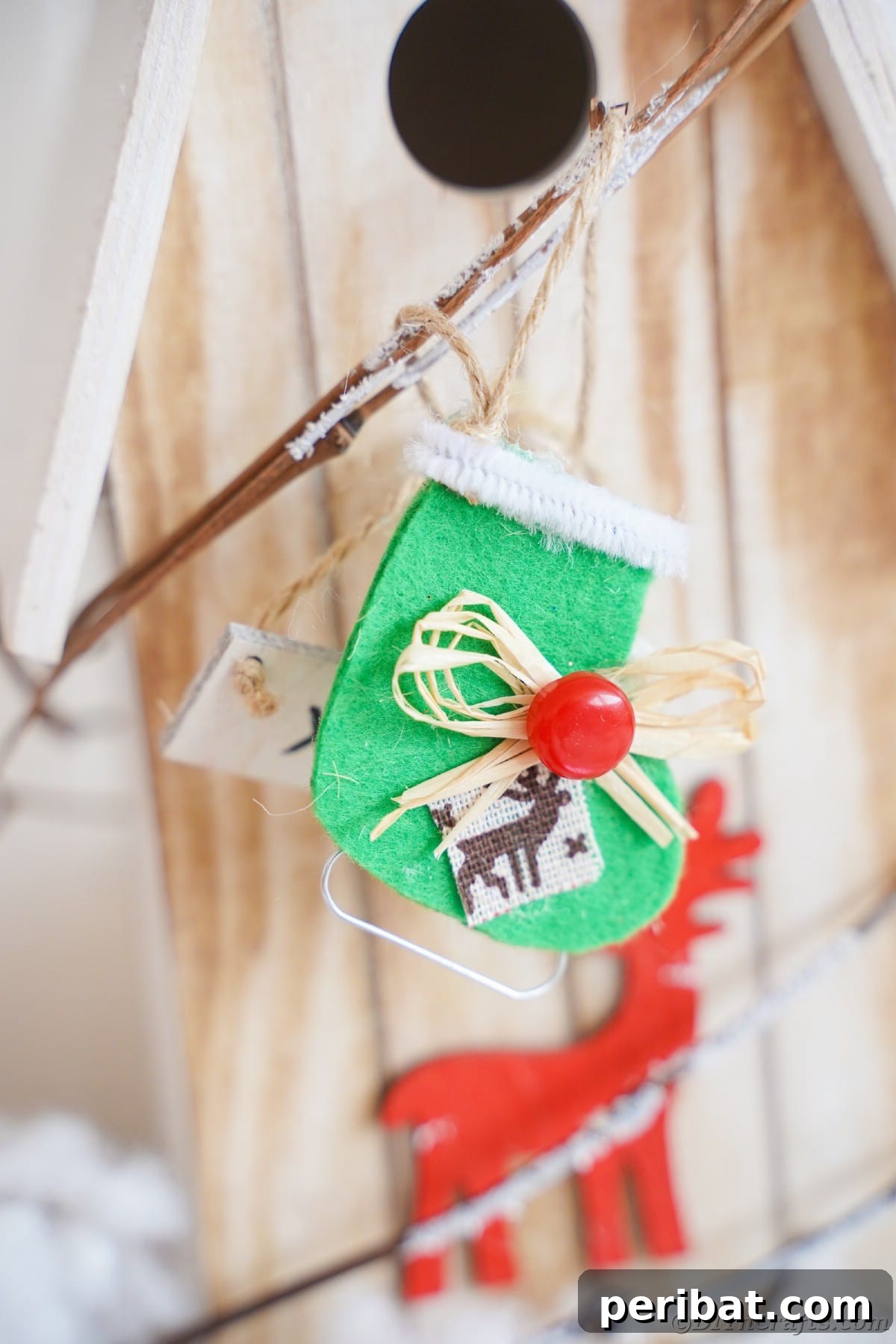 felt ice skate ornament hanging on wood bird feeder