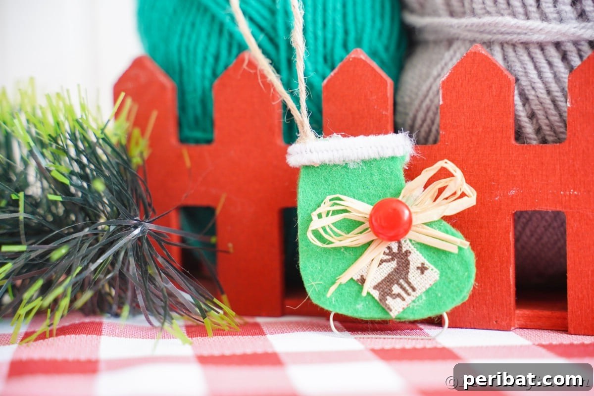 mini red fence with green ice skate ornament hanging off fence