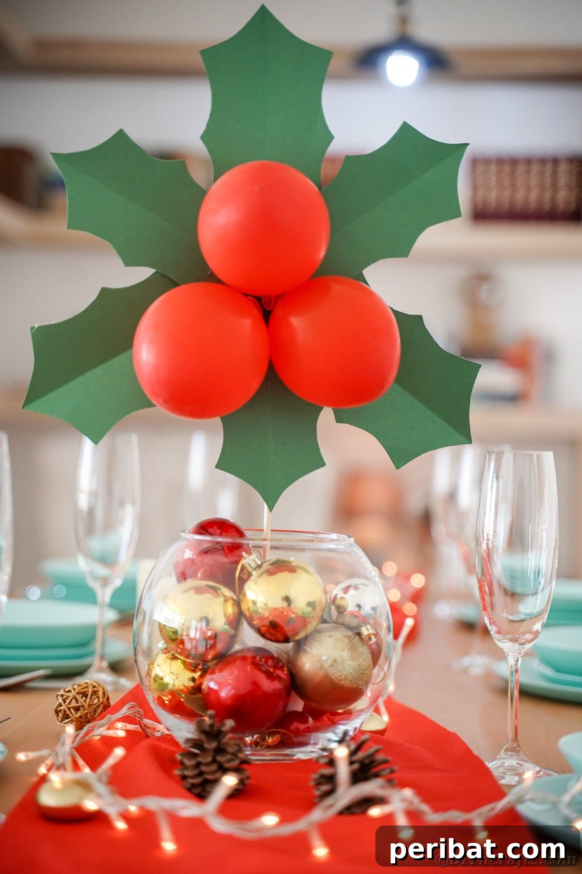 Oversized Holly Berry and Leaf Festive Decor 2 glass bowl with gold and red ornaments on table holding giant holly leaves