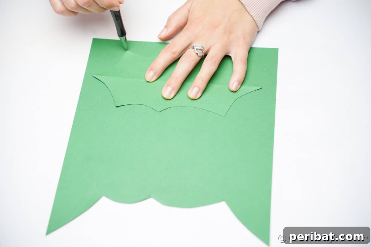 Oversized Holly Berry and Leaf Festive Decor 11 tracing leaf shape onto green paper