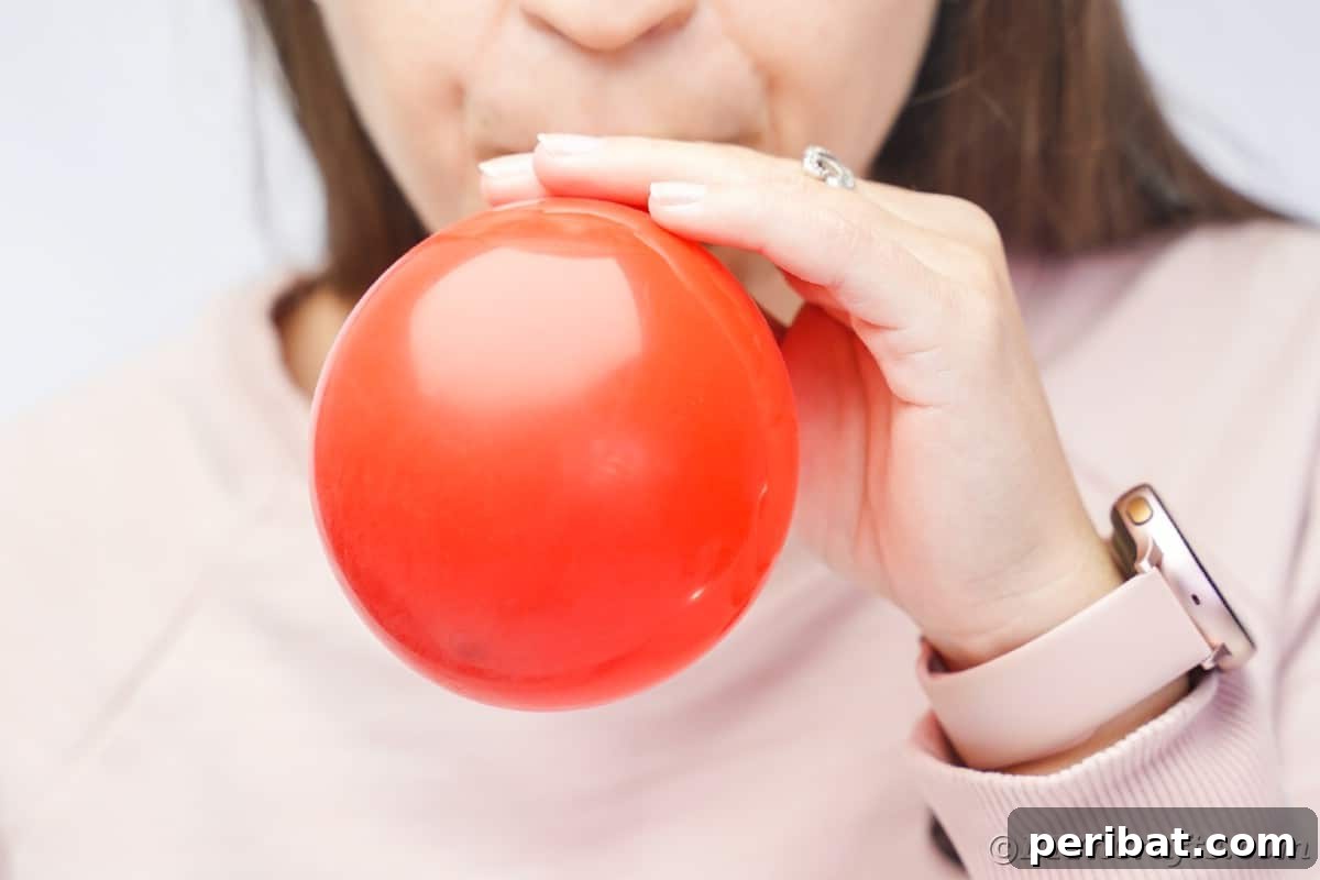Oversized Holly Berry and Leaf Festive Decor 12 woman blowing up red balloon