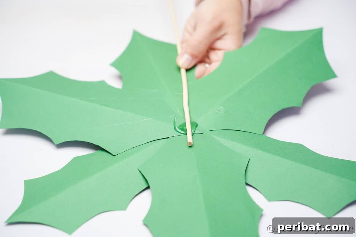 Oversized Holly Berry and Leaf Festive Decor 14 gluing dowel to back of green paper leaf