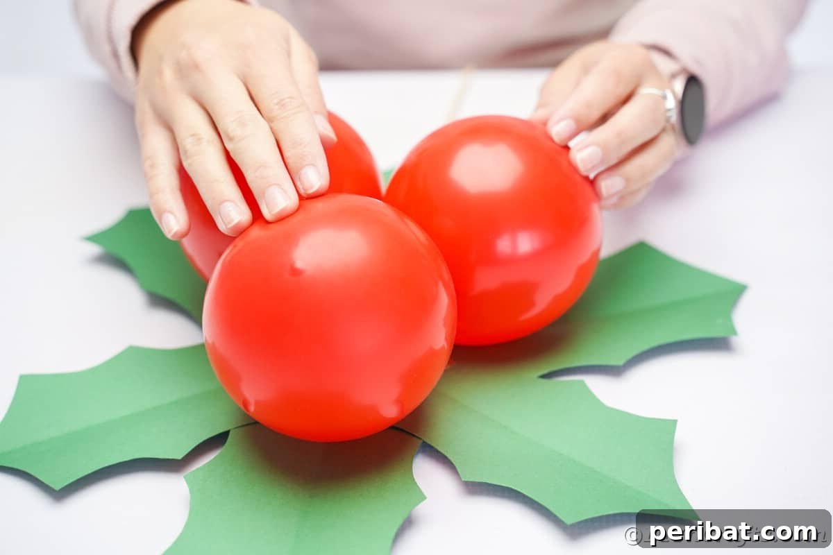 Oversized Holly Berry and Leaf Festive Decor 21 lady holding red balloons on top of green paper leaves