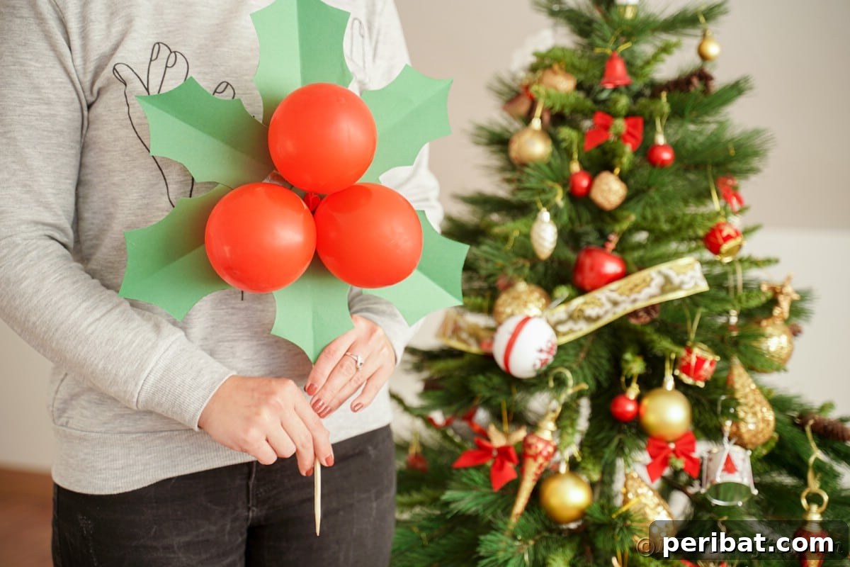 Oversized Holly Berry and Leaf Festive Decor 22 lady in black pants holding giant holly leaf and berries decoration