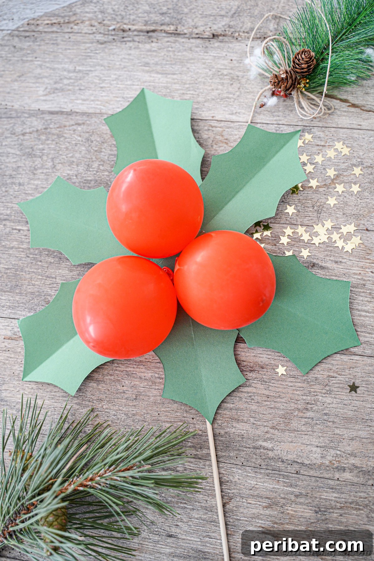 Oversized Holly Berry and Leaf Festive Decor 26 Christmas berry and leaf decorationo n gray table