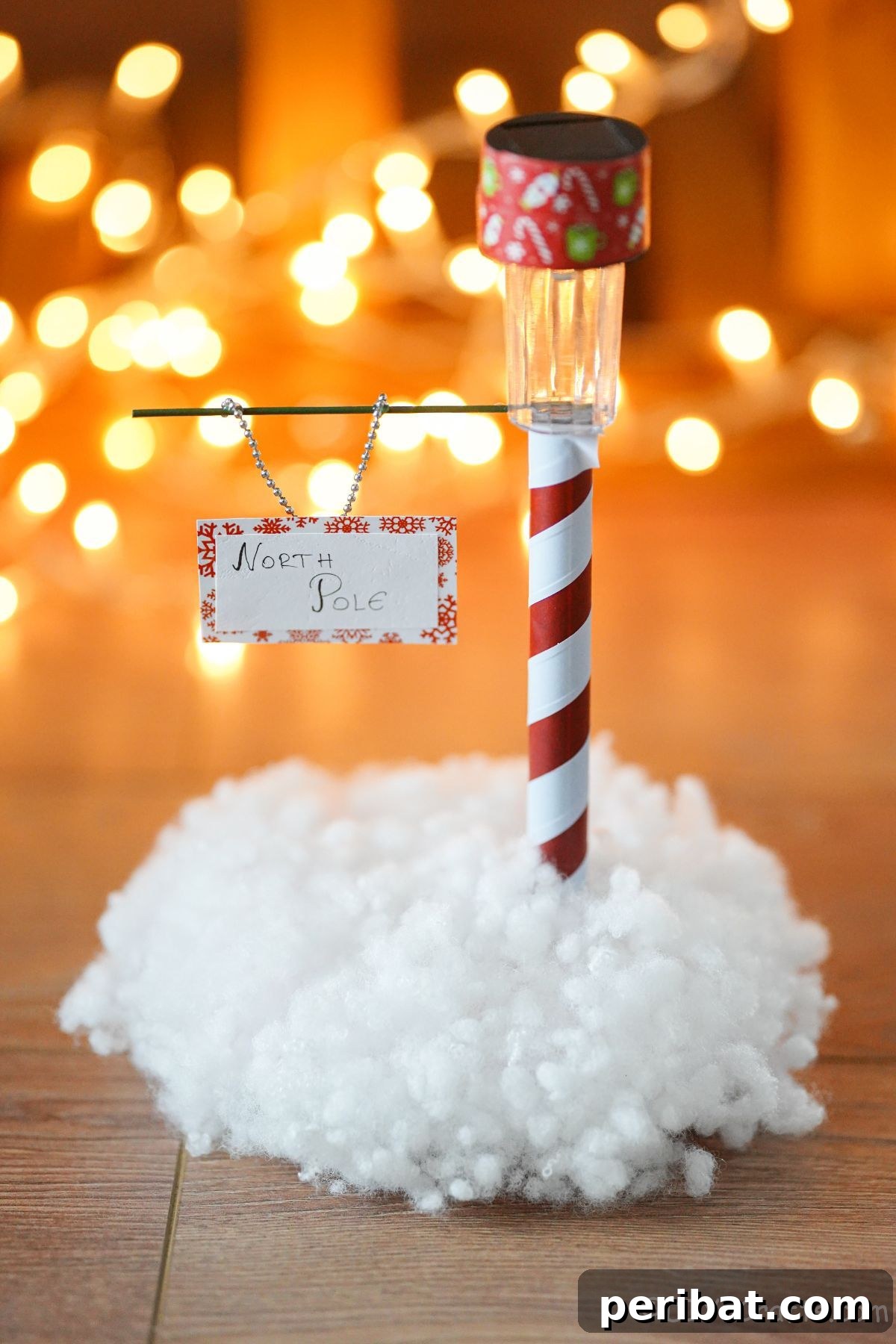 Whimsical Arctic Lamppost Craft 2 mini North Pole sign with fake snow in front of holiday lights